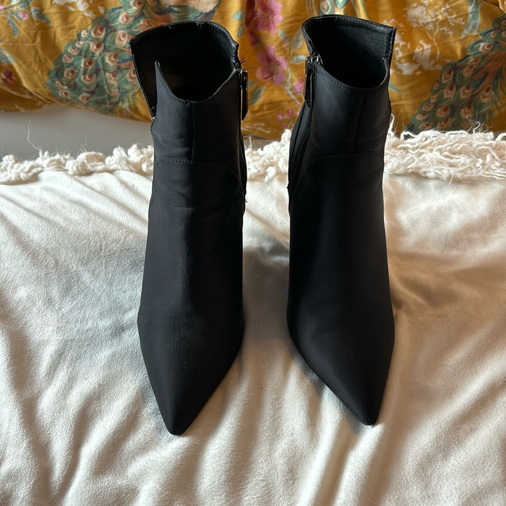 Satin finished wedged high heel bootie.